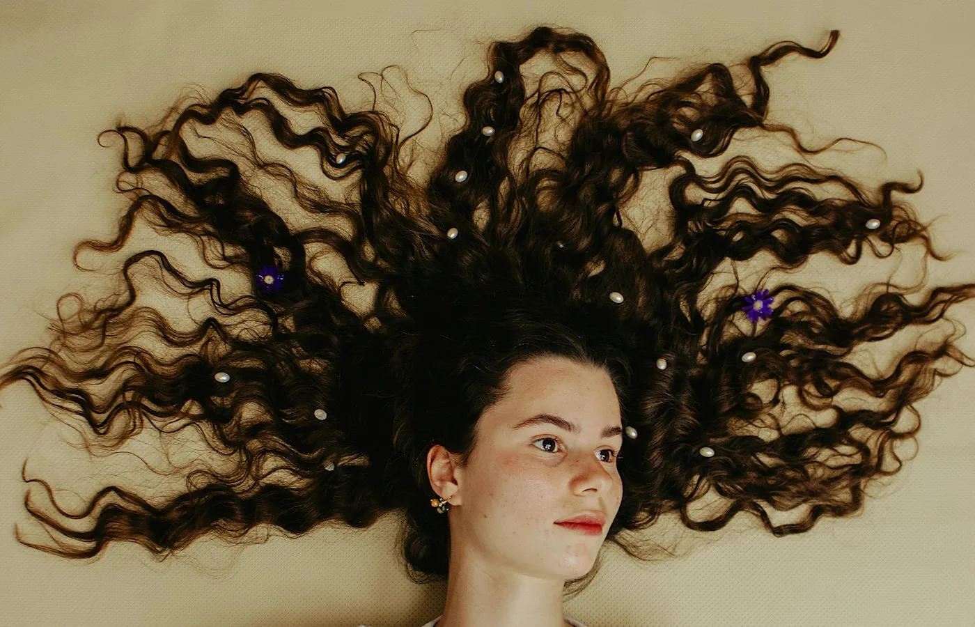 Curly hair spread out on a warm background
