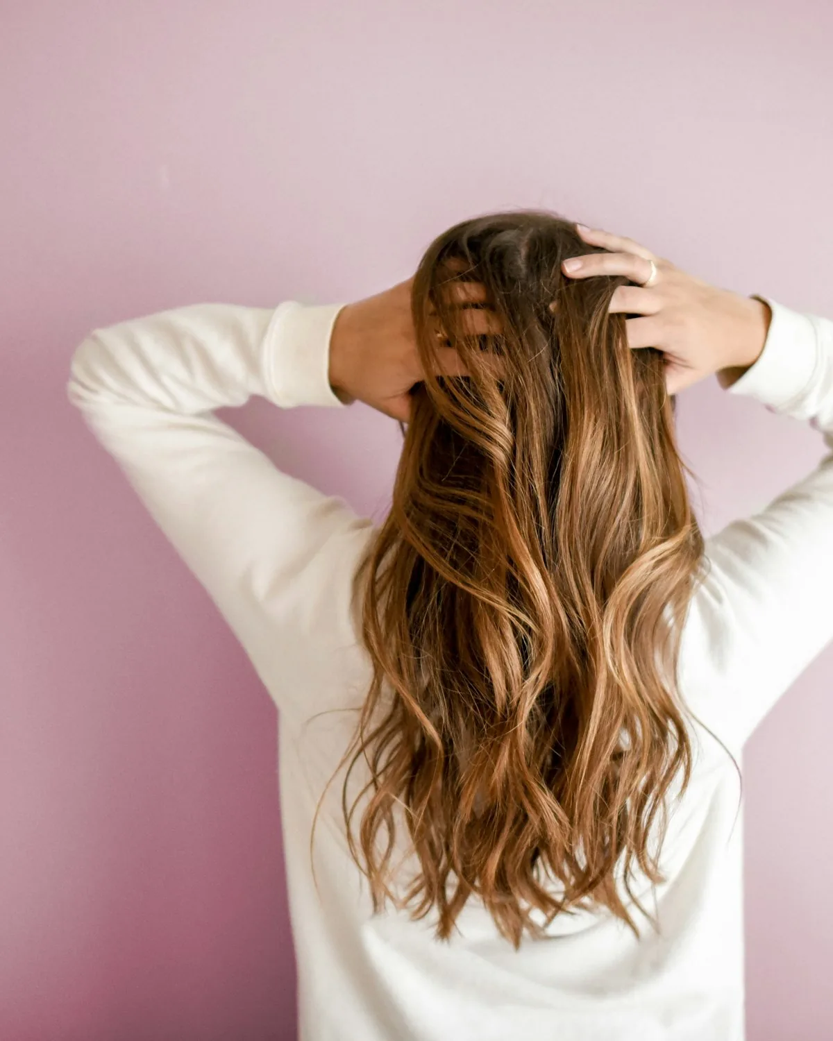 Model running hands through long hair