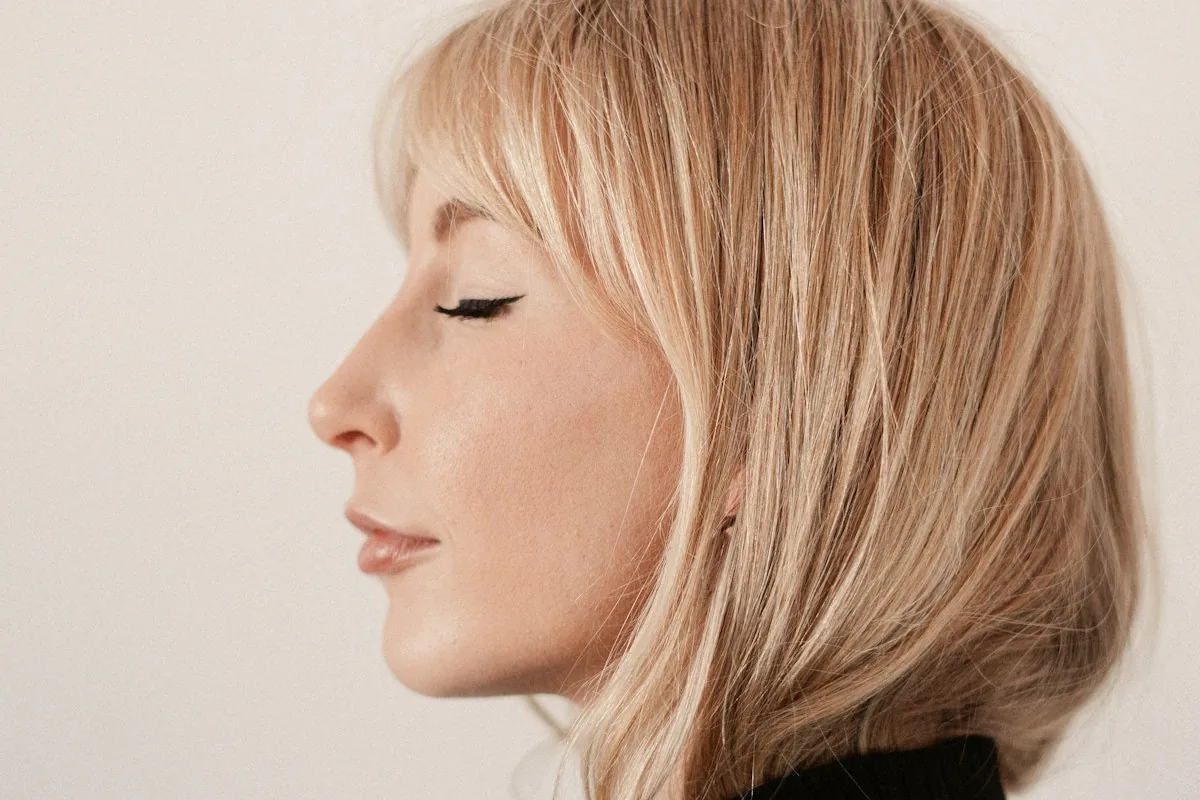 Blonde model in profile with a soft fringe