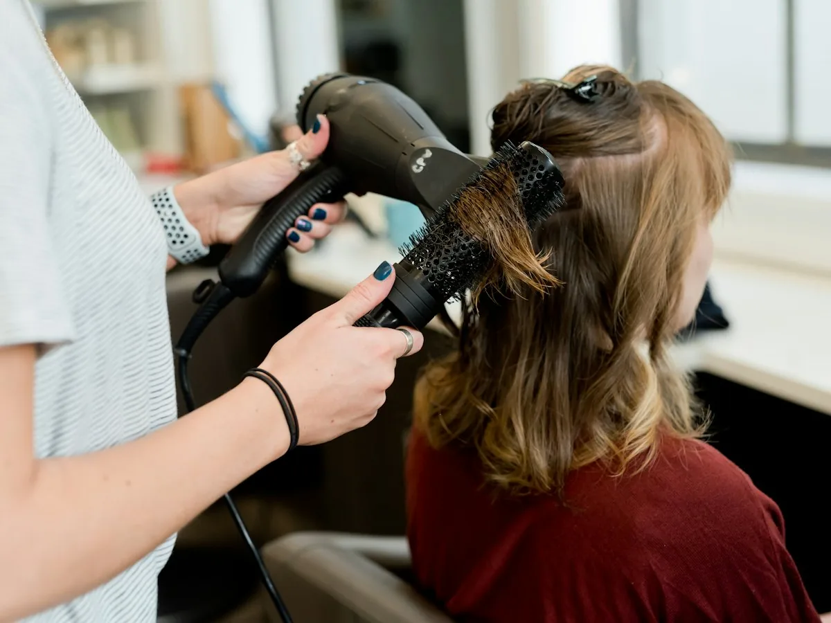 Stylist blow-drying with a round brush
