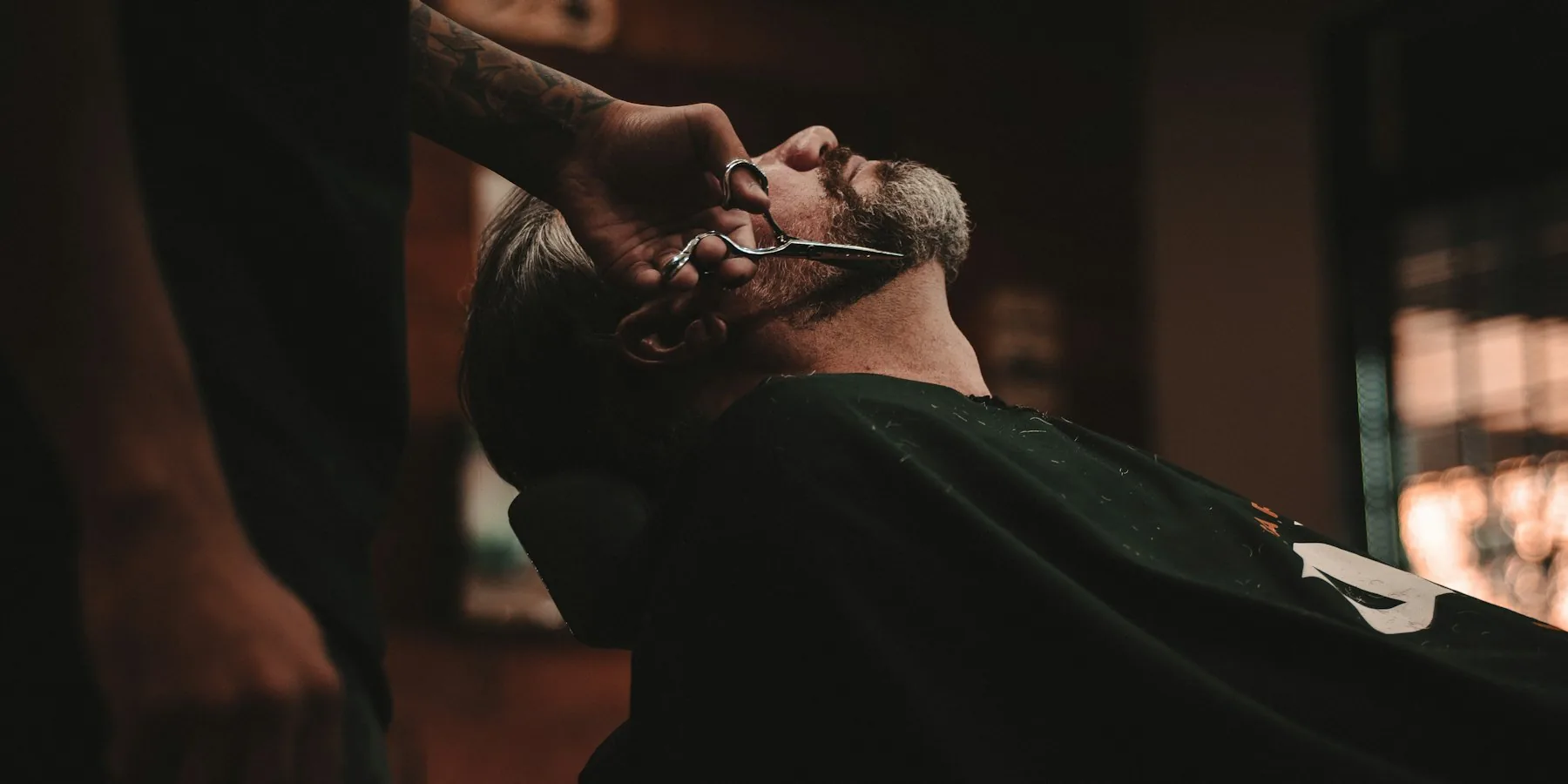 Barber at work in low light