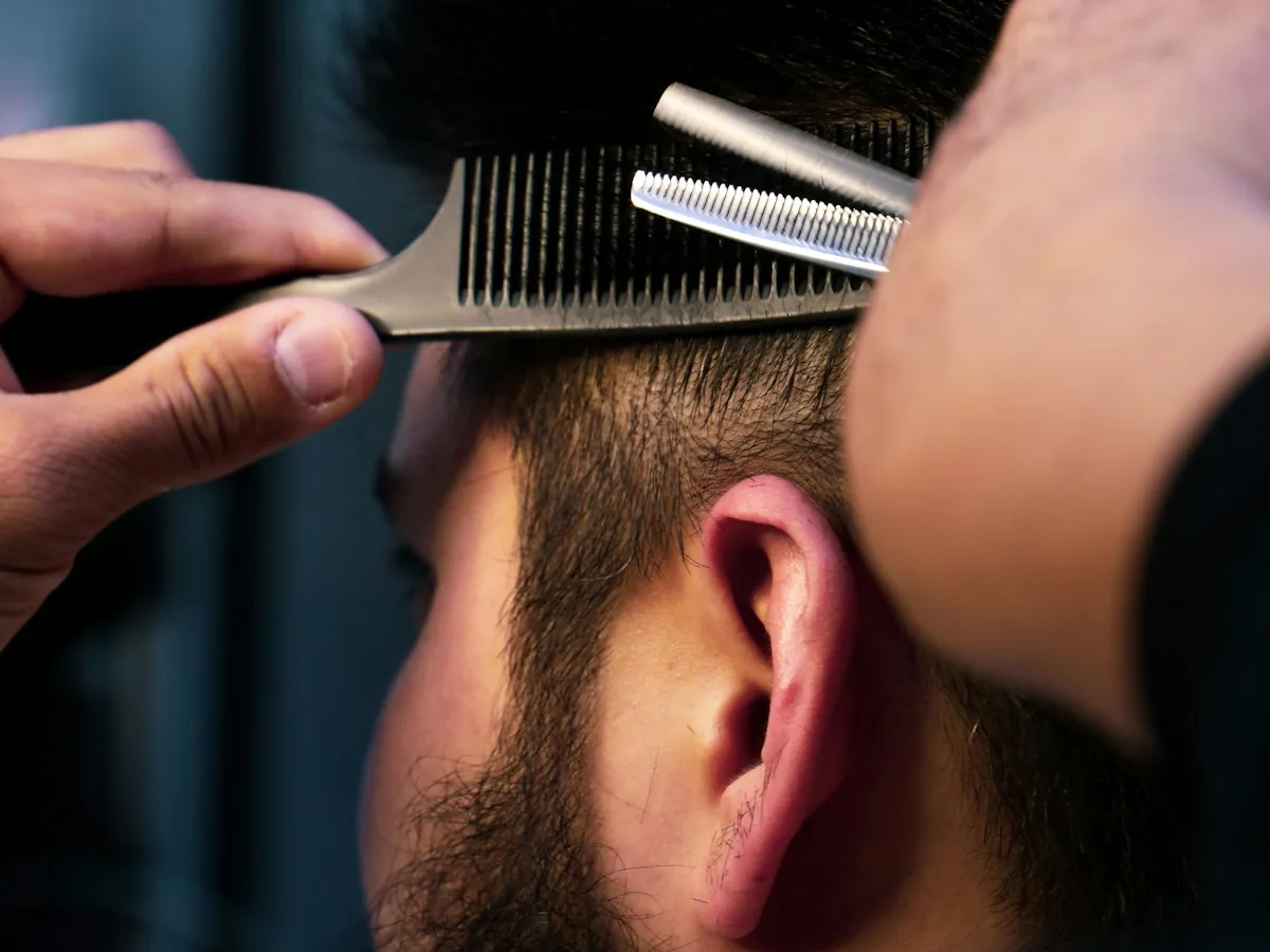 Stylist cutting with a comb and shears
